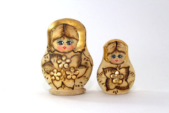 Two wooden nested dolls on a white background close-up
