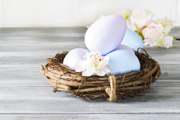 Easter background with Easter eggs and spring flowers. With copy space.