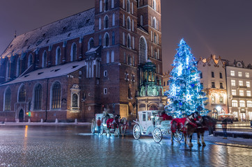 Fototapeta Krakow, Poland, Christmas tree and St Mary's church on Main Market square obraz