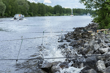 Summer landscape with fishing rods on background of lake, opposite shore, morning, Yacht, beach with stones. Seasons, ecology, ctive rest, hobby, countryside relaks © svetlanais