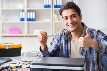 Hardware repairman repairing broken printer fax machine