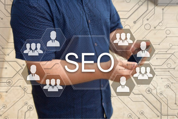Search engine optimization.SEO on the touch screen with a blur background of the businessman with...