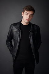 Fototapeta premium Attractive young man on the gray background for shopping