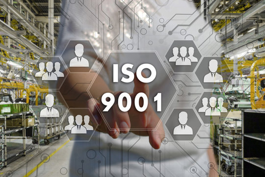 The businesswoman chooses  button  ISO 9001 on the touch screen with a futuristic background .The concept   ISO 9001.