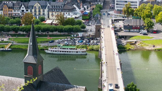 Timelapse of a bridge over Moselle River in Cochem, Eifel in Germany with lots of people and cars passing.