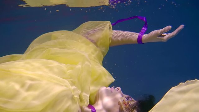 Charming woman dressed underwater