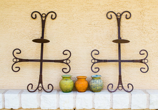 ceramic pottery and metal crosses decorating a townhouse patio