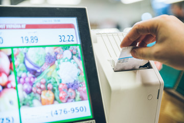 man weigh fruits on digital scales
