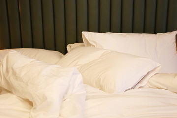 empty bed with pillows at the bed room of the hotel