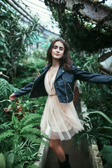 Full length portrait of dancing stylish woman on nature background