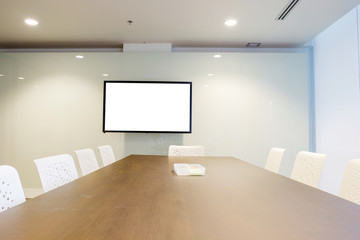 Naklejka na ściany i meble Inside the medium room with long table, modern chair and blank LCD TV used for conferences, meetings, brainstorming, training and share your opinion, Interior room for business team and education 