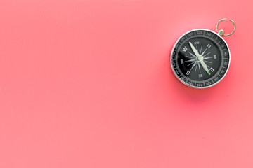 Compass on pink background top view copy space