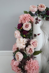 a bouquet of spring pink beautiful flowers near the bed in the bedroom with grey wall. hello march april may