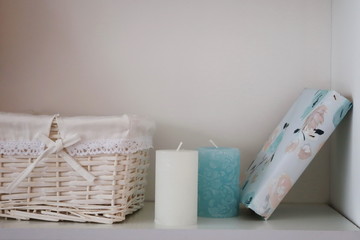 basket candles and book in the interior of the room