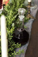 Bottle of red wine with green leaves