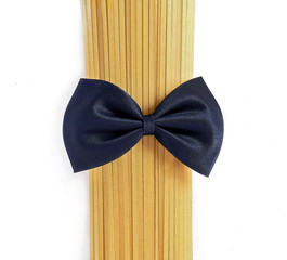 Raw pasta, macaroni tied with a bow tie, on a white background. Mr. Spaghetti.	
