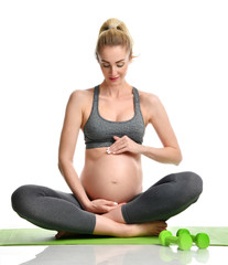 Pregnant woman doing sport stretching exercises green weights. Pregnancy motherhood expectation healthy life and weight control concept