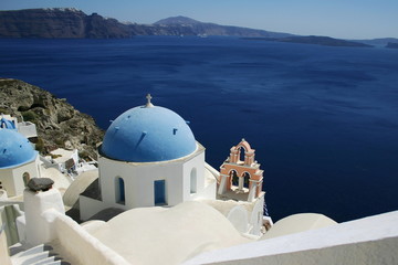 blue and white church with bells at the Santorini island Greece