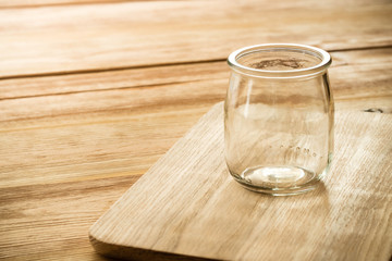 Empty glass jar on a wooden table