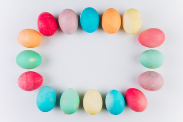 Preparation for Easter. Сolored eggs on a blue background, flat lay and top view.