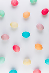 Preparation for Easter. Сolored eggs on a blue background, flat lay and top view.
