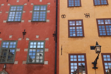 red and yellow facades of old houses on the street of stockholm sweden