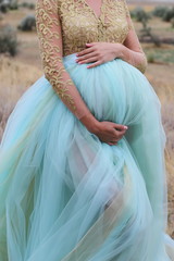 a pregnant wo.an in blue beautifull dress