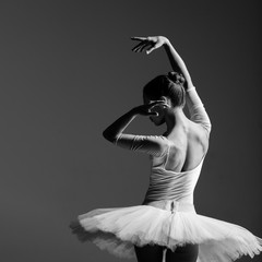 Naklejka premium Young beautiful ballerina is posing in studio