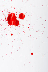 drops of red blood on white paper