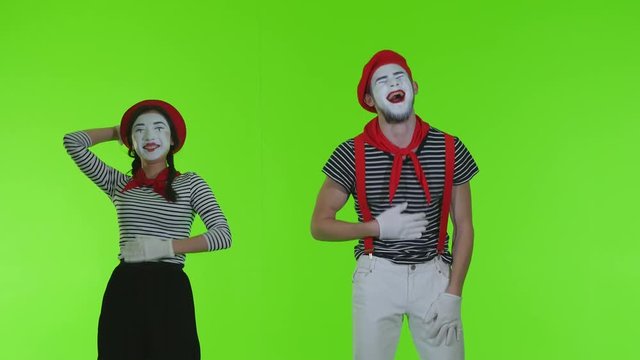 Mimes are laughing on a green background