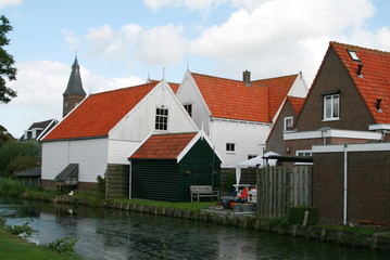 Fototapeta na wymiar wooden houses with red roofs in the Marken village Netherlands