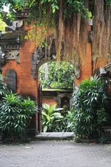 Fototapeta na wymiar Balinese temple gate entrance with plants in Bali Indonesia