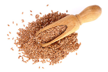 flax seeds in wooden scoop isolated on white background. Top view