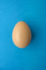 White egg on the blue background in center. Design, visual art, minimalism