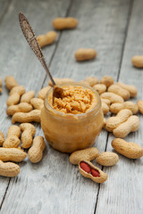 an open jar of peanut butter with spoon