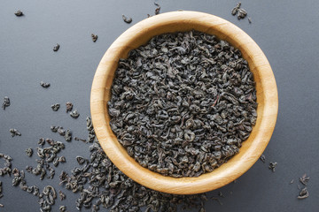 black tea leaves in a wooden bowl