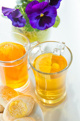 isolated tea with lemon and cookies on white background. Still life in a high key.