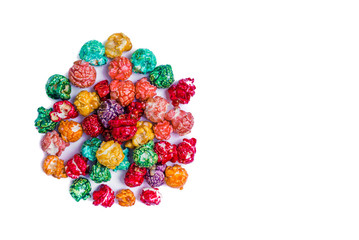 Brightly Colored Candied Popcorn, white background. Image of Junk food, fruit flavored popcorn. Colorful, rainbow, candy coated popcorn in old metal cup. Isolated on white selective focus 