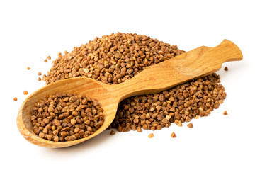 Bunch of buckwheat and wooden spoon on a white, isolated.