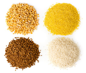 Four kinds of groats. A bunch of buckwheat, rice, dry peas and wheat, top view.