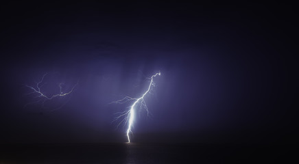 3d render of a black laptop isolated on white. The screen shows blue cyan flames and  abstract wave image. the screen is open and facing forward