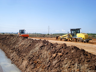 Fototapeta premium Grader and compactor on construction site