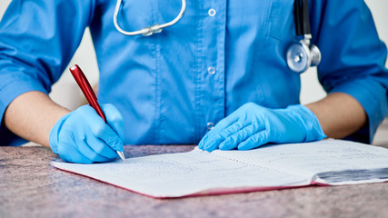close up vet doctor writing the diagnosis