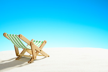Fototapeta na wymiar Sun lounger on the sandy beach
