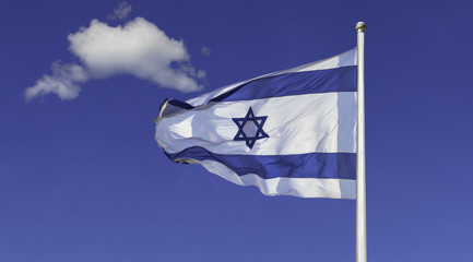 Israel flag in the wind isolated against the sky