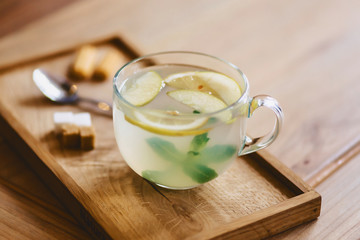 tea with lemon on a wooden stand with cookies