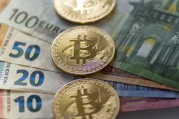 Bitcoin coins on euro banknotes - Stock image