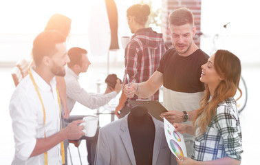 Obraz premium group of designers discuss men's suit