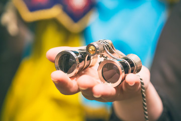 Theater concept. Vintage binoculars in female hand in theatre or opera