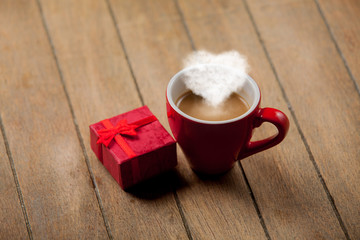 Obraz na płótnie Canvas Red cup of coffee with heart shape steam